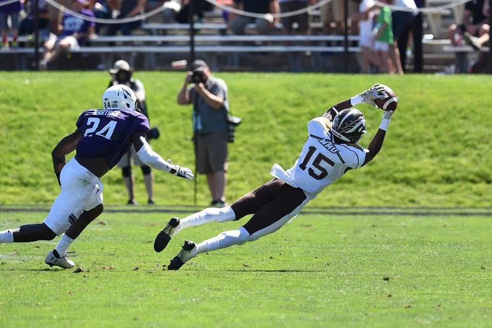 Carrington Thompson wearing number 15 dives to make a catch for Western Michigan